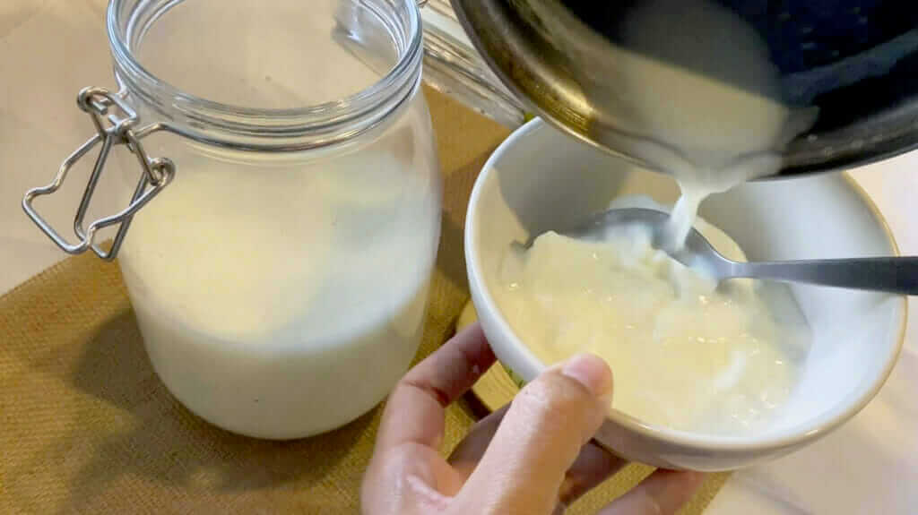 mixing raw milk and yogurt by hand